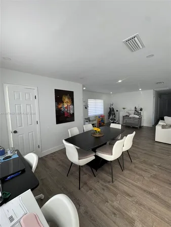 a living room with furniture a rug and a table