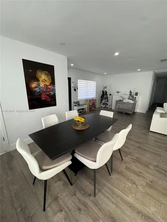 a living room with furniture a rug and a wall painting