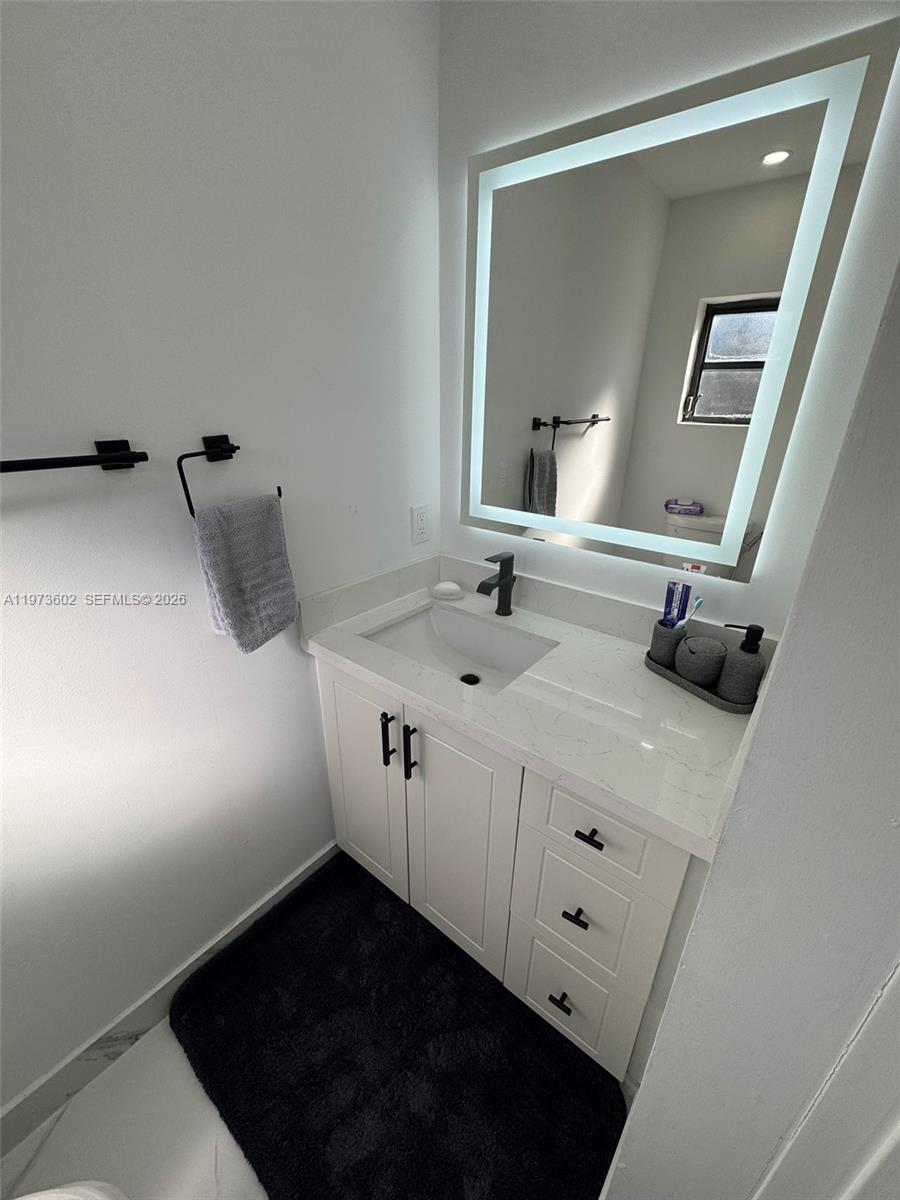 12534 Southwest 27th Street Miami, FL 33175 - Photo 17 of 49 a bathroom with a sink and a mirror