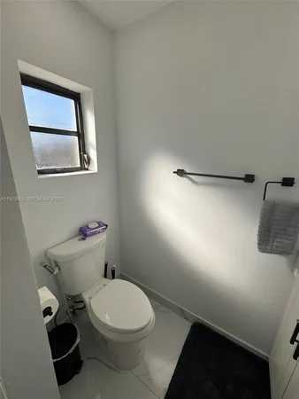 a white toilet sitting next to a bathroom sink