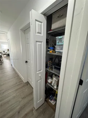 a view of hallway with wooden floor