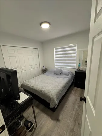 a bedroom with a bed and a dresser