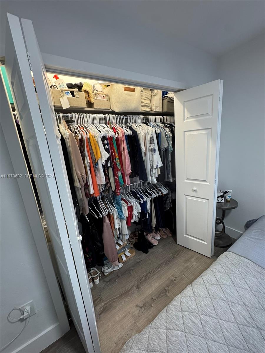 12534 Southwest 27th Street Miami, FL 33175 - Photo 27 of 49 a view of walk in closet with clothes and shoes