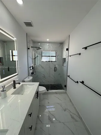 a bathroom with a sink toilet and shower