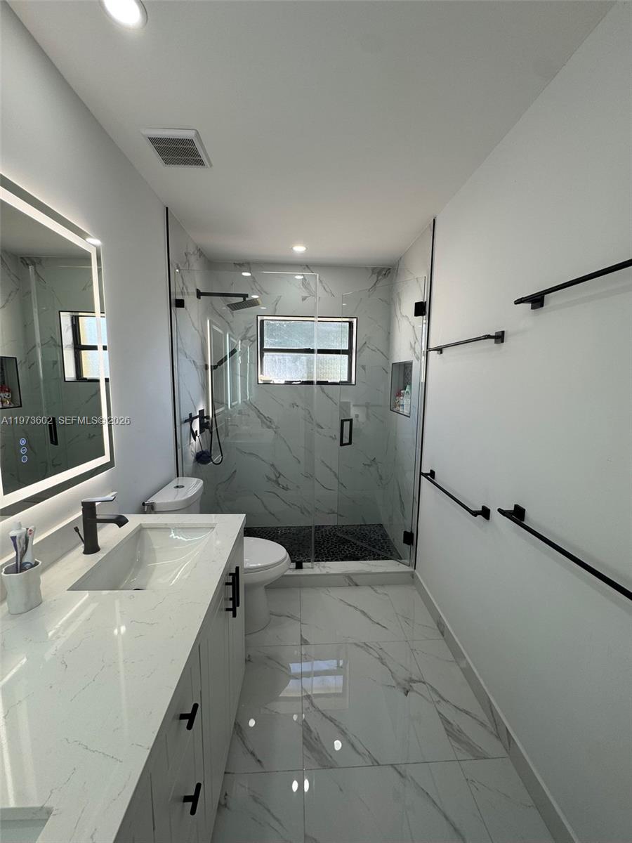 12534 Southwest 27th Street Miami, FL 33175 - Photo 28 of 49 a bathroom with a sink toilet and shower