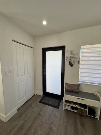 a view of a room with wooden floor