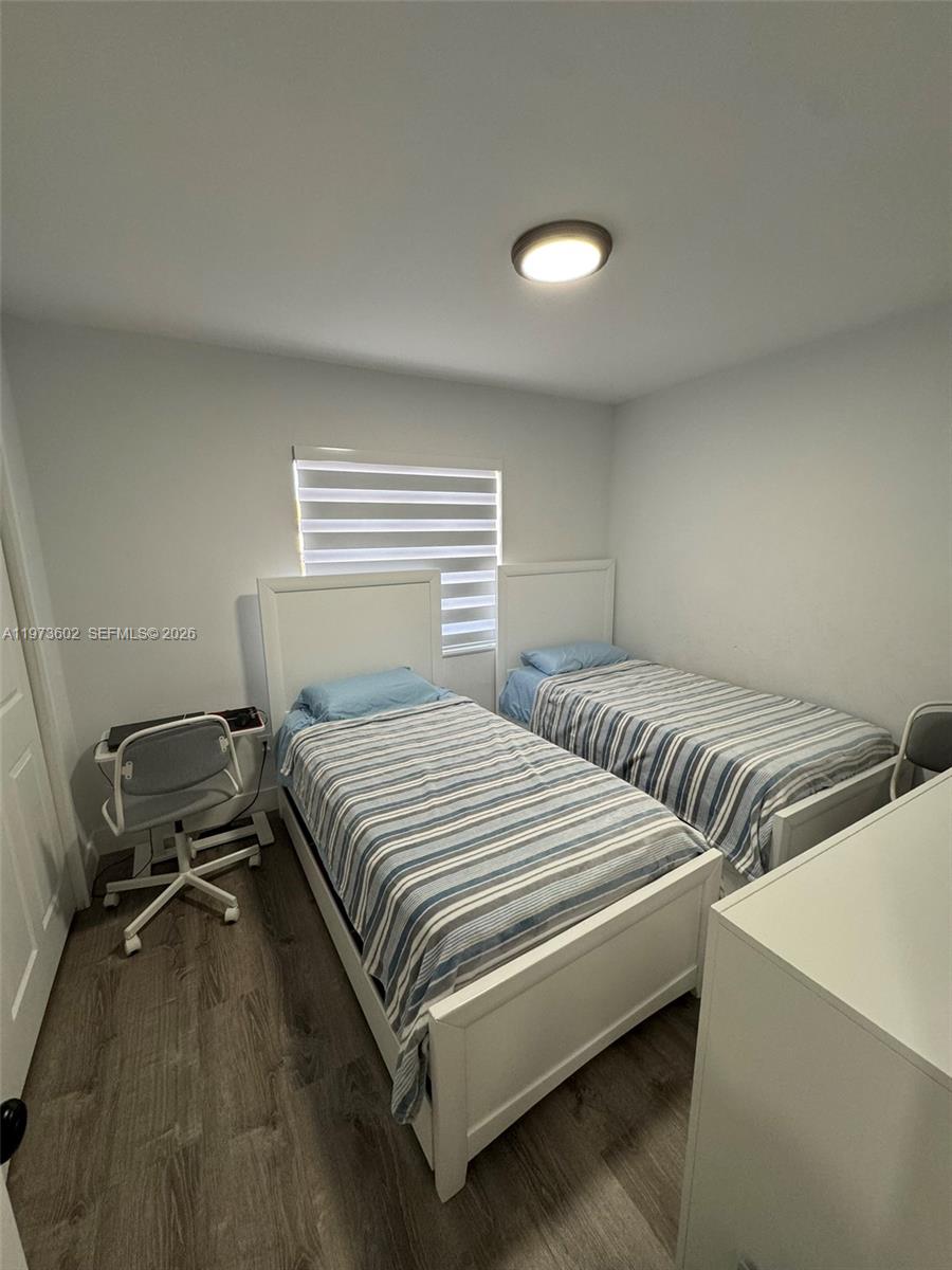 12534 Southwest 27th Street Miami, FL 33175 - Photo 31 of 49 a bedroom with two beds and a desk