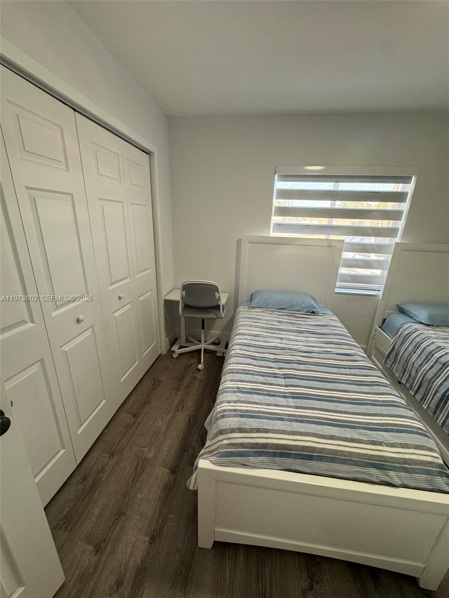12534 Southwest 27th Street Miami, FL 33175 - Photo 32 of 49 a bedroom with a bed and wooden floor