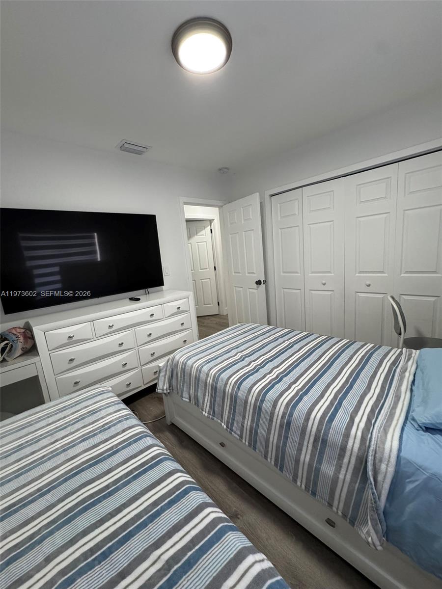 12534 Southwest 27th Street Miami, FL 33175 - Photo 33 of 49 a bedroom with two beds and a flat screen tv