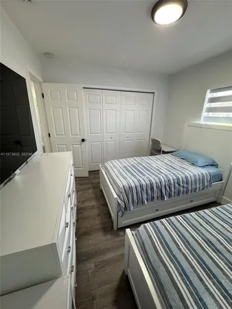 a bedroom with bed and window