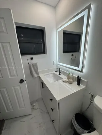 a bathroom with a double vanity sink and mirror
