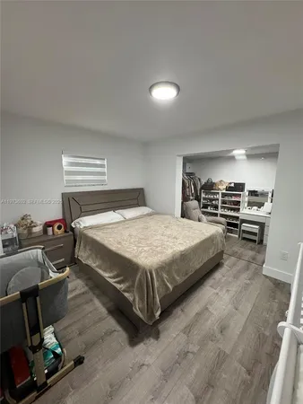 a bedroom with a bed a table and chair