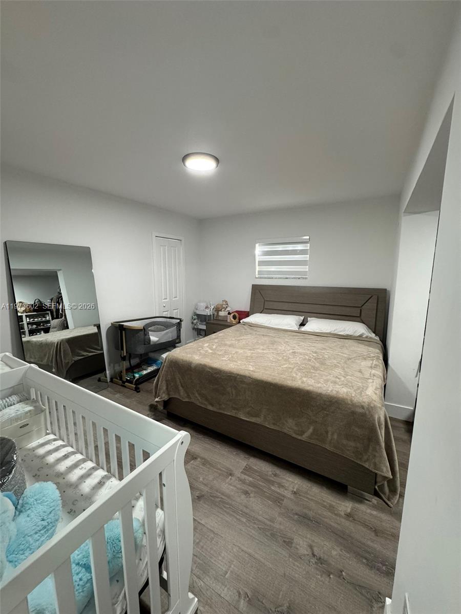 12534 Southwest 27th Street Miami, FL 33175 - Photo 43 of 49 a bedroom with two beds and wooden floor
