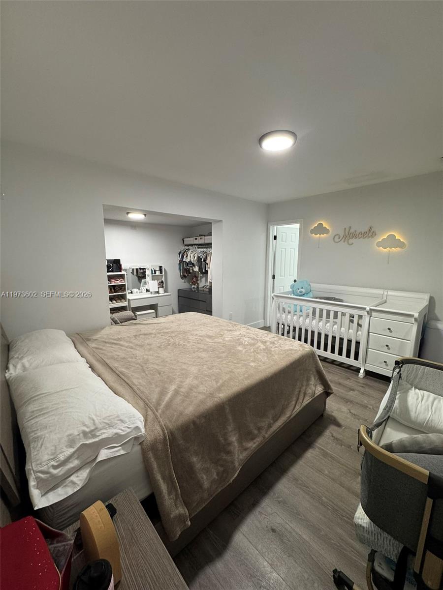 12534 Southwest 27th Street Miami, FL 33175 - Photo 45 of 49 a spacious bedroom with a bed a desk and chair