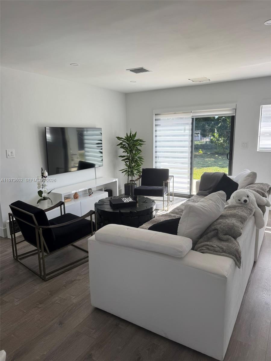 12534 Southwest 27th Street Miami, FL 33175 - Photo 6 of 49 a living room with furniture and a flat screen tv