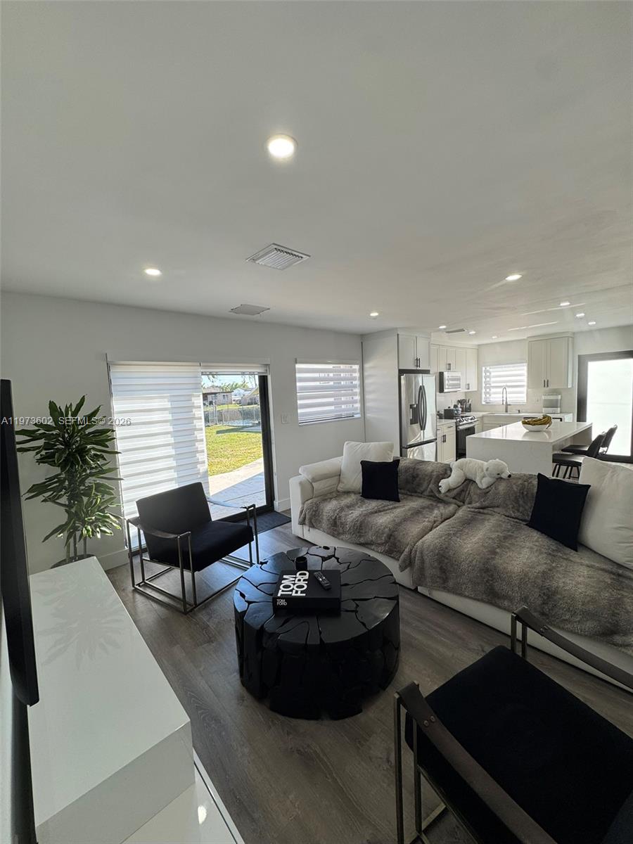 12534 Southwest 27th Street Miami, FL 33175 - Photo 8 of 49 a living room with furniture kitchen view and a large window
