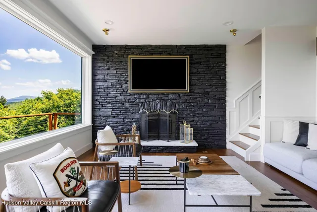 a room with furniture pool table flat screen tv and windows