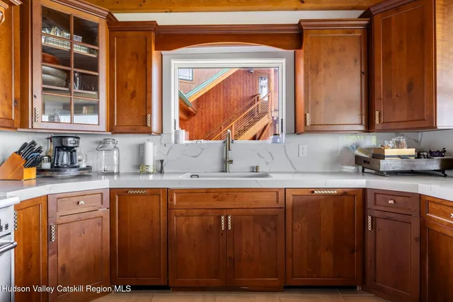 a dining room with furniture a flat screen tv and a large window