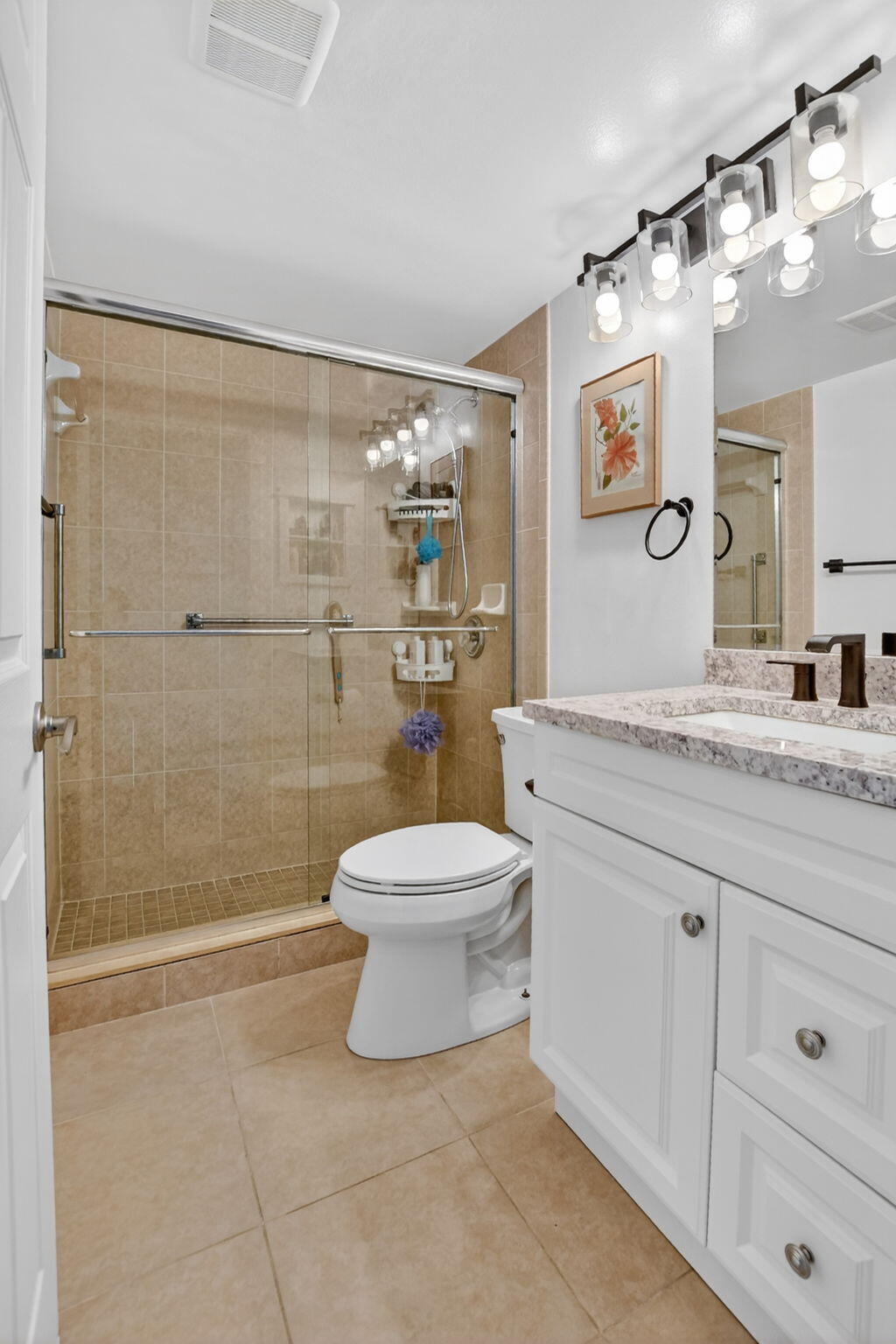 4051 Guilford C Boca Raton, FL 33434 - Photo 16 of 44 a bathroom with a granite countertop toilet a sink a mirror and shower