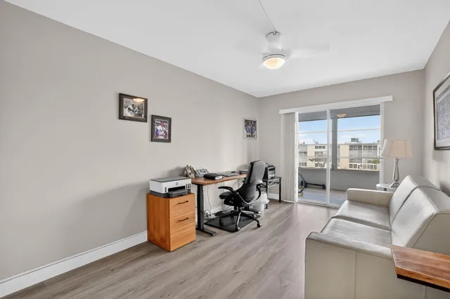 a view of a livingroom with workspace and a window