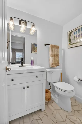 a bathroom with a sink toilet and mirror