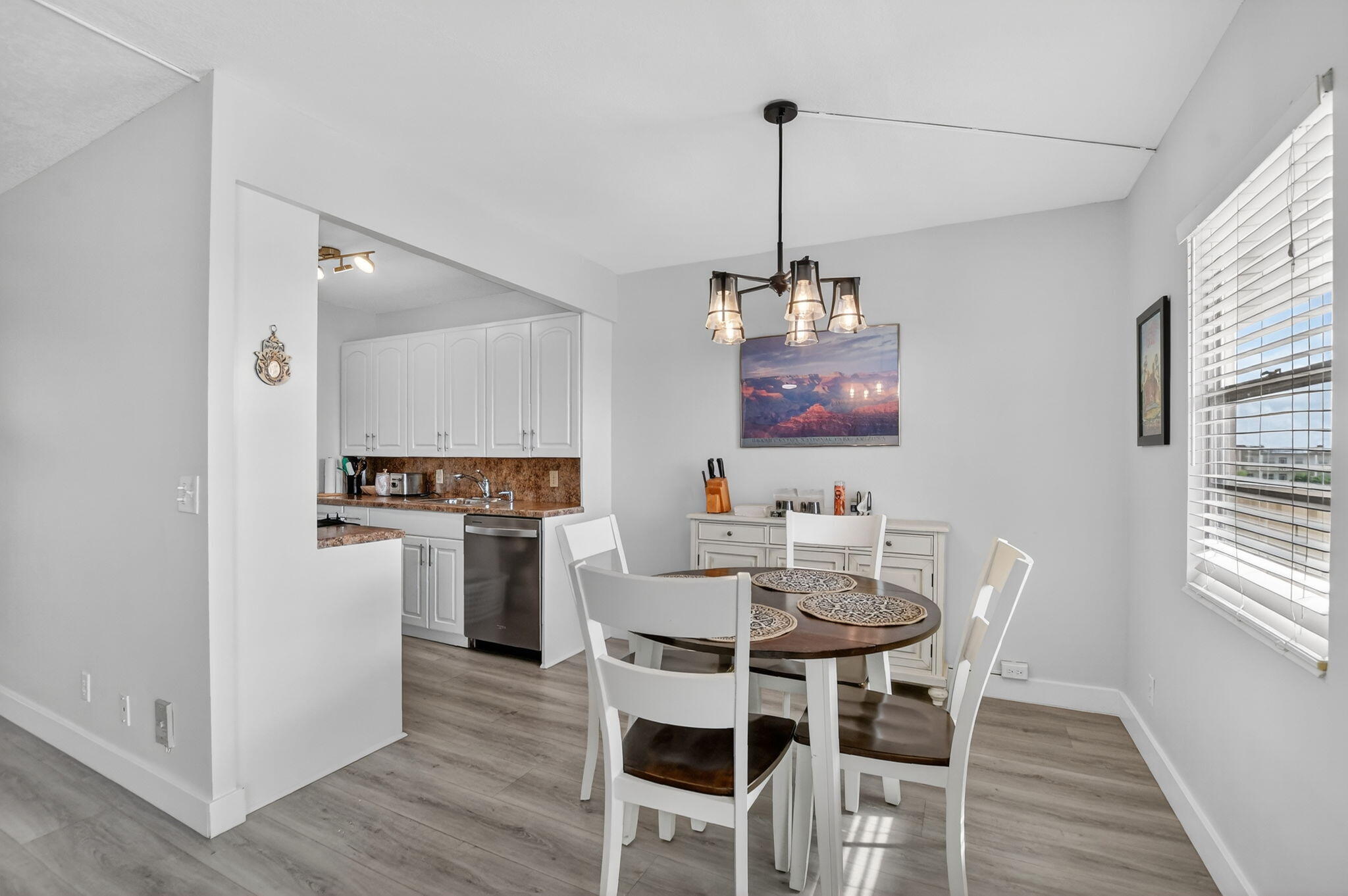 4051 Guilford C Boca Raton, FL 33434 - Photo 6 of 44 a view of a dining room and livingroom with furniture wooden floor a chandelier