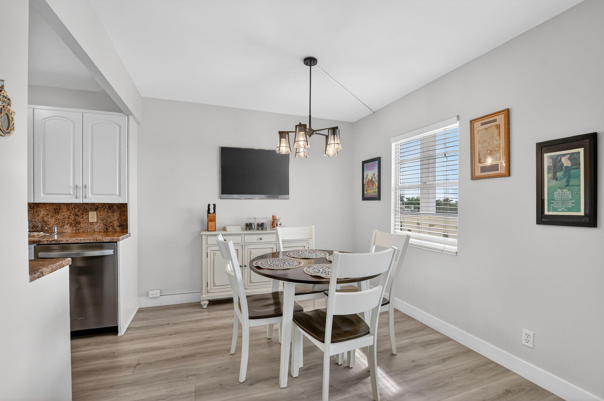 4051 Guilford C Boca Raton, FL 33434 - Photo 8 of 44 a view of a dining room with furniture wooden floor and a chandelier