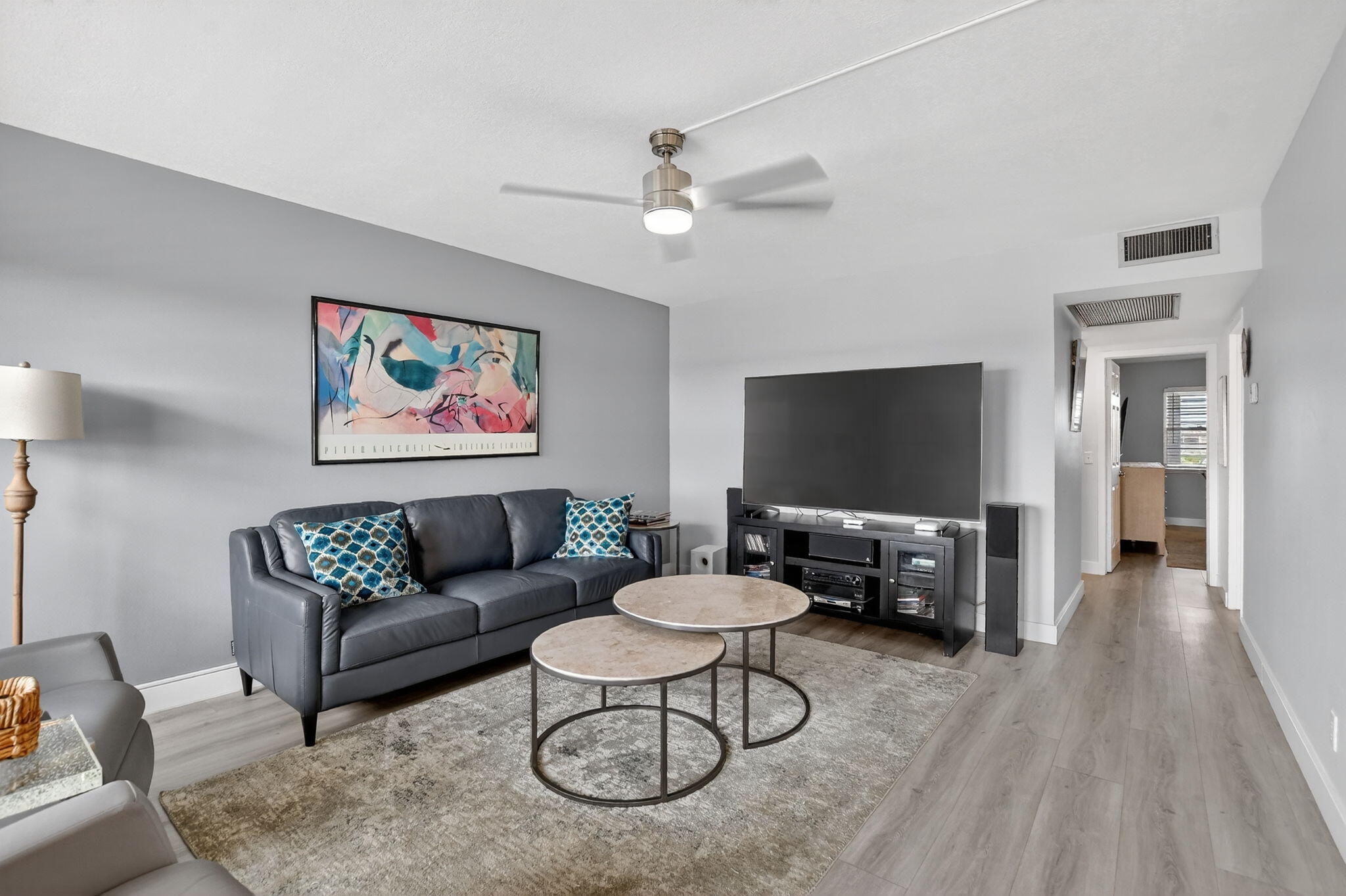 4051 Guilford C Boca Raton, FL 33434 - Photo 9 of 44 a living room with furniture and a flat screen tv with wooden floor