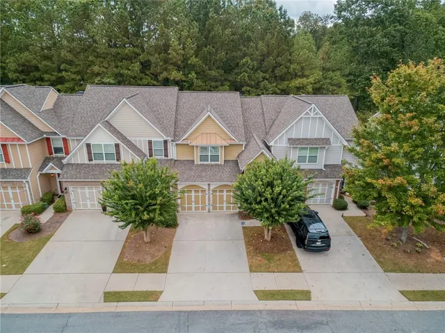 a house with lots of trees in the background