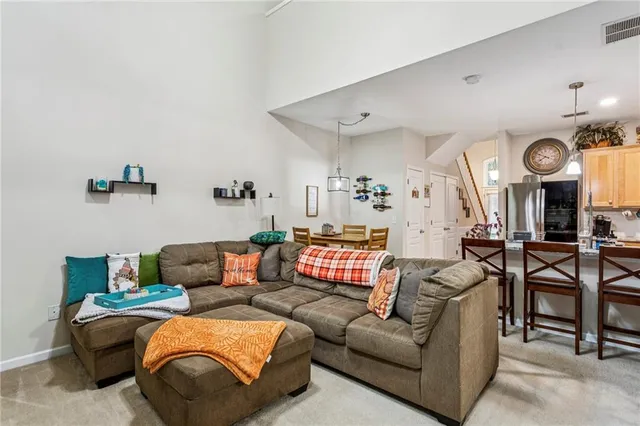 a living room with furniture and a clock