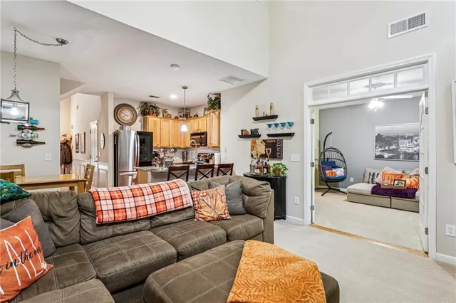 a living room with furniture and a chandelier
