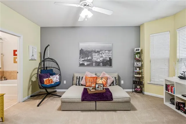 a living room with furniture a rug and a window