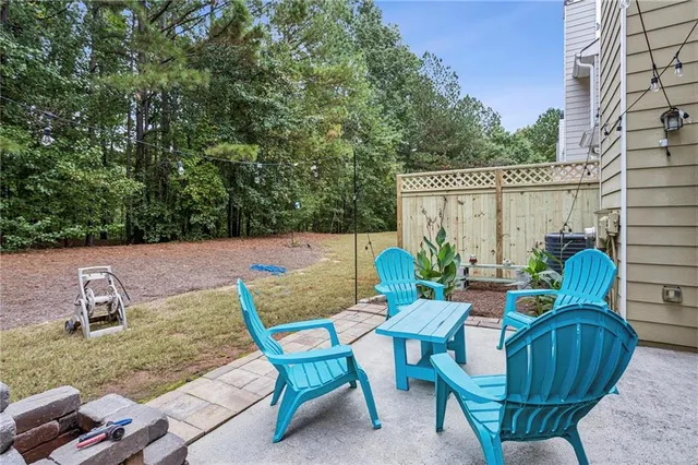 a view of a chairs and table in the backyard