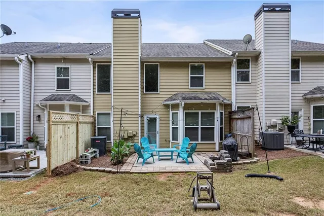 a view of a house with backyard porch and sitting area