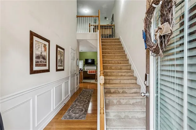 a view of an entryway with wooden floor and stairs