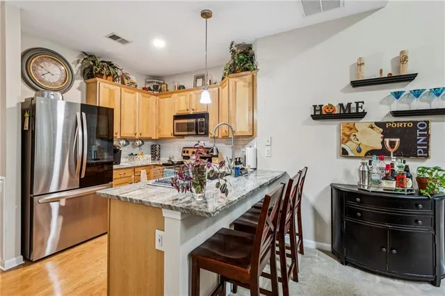 a kitchen with sink refrigerator and cabinets