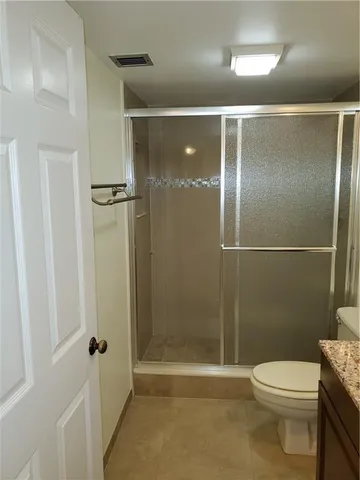 a bathroom with a toilet and a shower