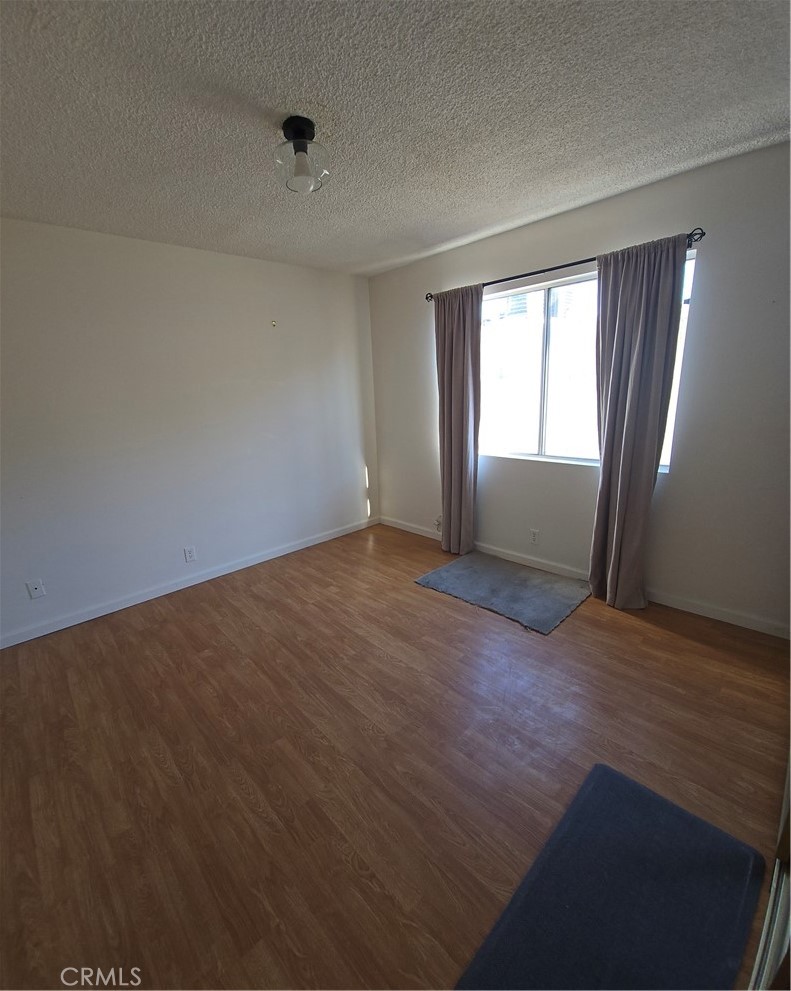 12157 Moorpark Street, Unit 206 Studio City, CA 91604 - Photo 11 of 17 a view of an empty room with wooden floor and a window