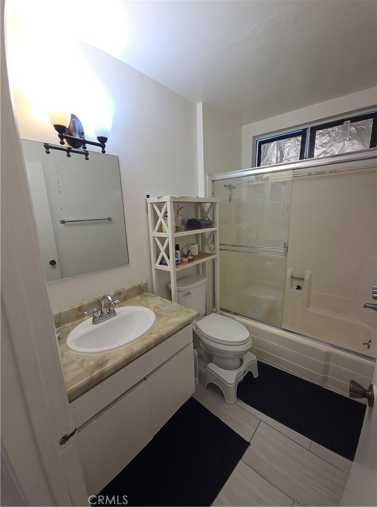 12157 Moorpark Street, Unit 206 Studio City, CA 91604 - Photo 12 of 17 a bathroom with a sink a toilet and mirror