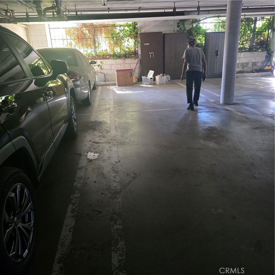 12157 Moorpark Street, Unit 206 Studio City, CA 91604 - Photo 2 of 17 a backyard of a house with table and chairs