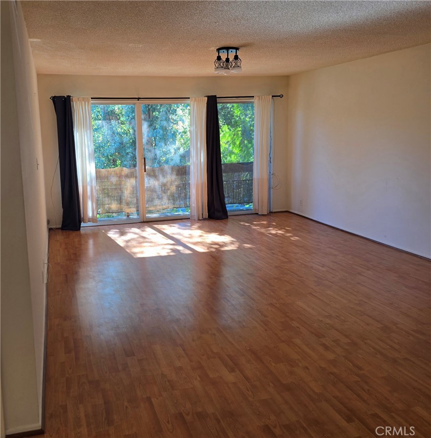 12157 Moorpark Street, Unit 206 Studio City, CA 91604 - Photo 4 of 17 a view of an empty room with wooden floor and a window