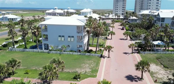 a aerial view of a house with a yard and a fountain