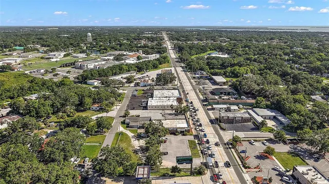 an aerial view of residential houses with outdoor space and swimming pool