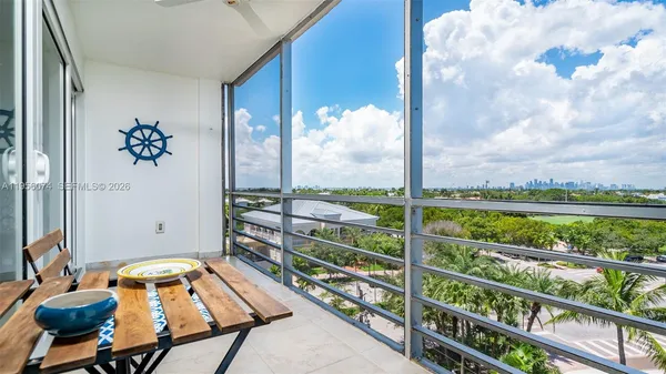 a view of a balcony with chair and table