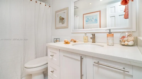a bathroom with a sink toilet and vanity