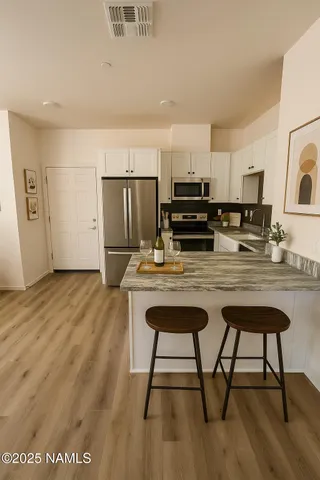 a kitchen with kitchen island a stove a refrigerator and wooden cabinets