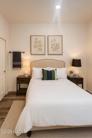 a bedroom with a bed and a tv