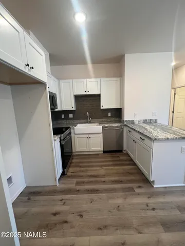 a kitchen with a sink a stove and cabinets