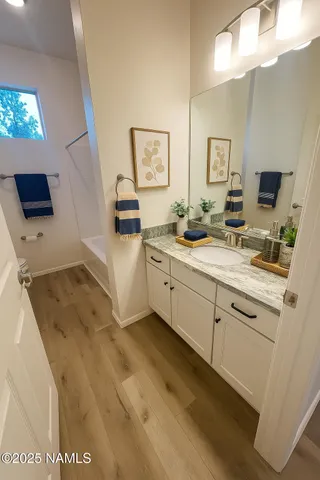 a spacious bathroom with a sink mirror and vanity