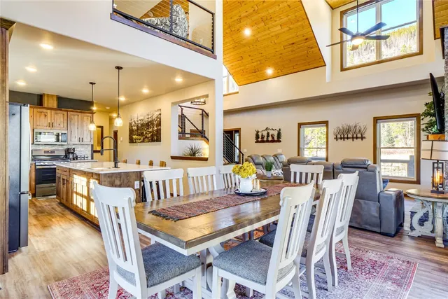 a dining room with furniture and a floor to ceiling window